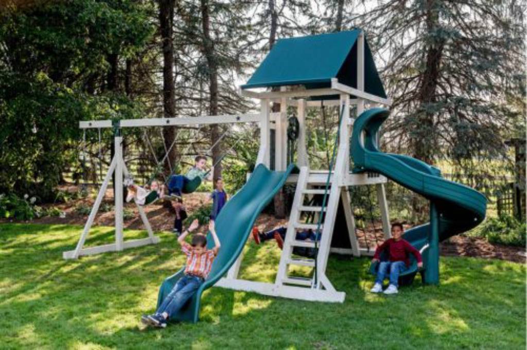galaxy swing set with three swings with kids on green slides
