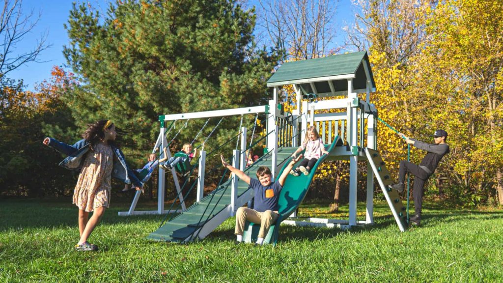 children playing on green and white silver star vinyl swing set for sale