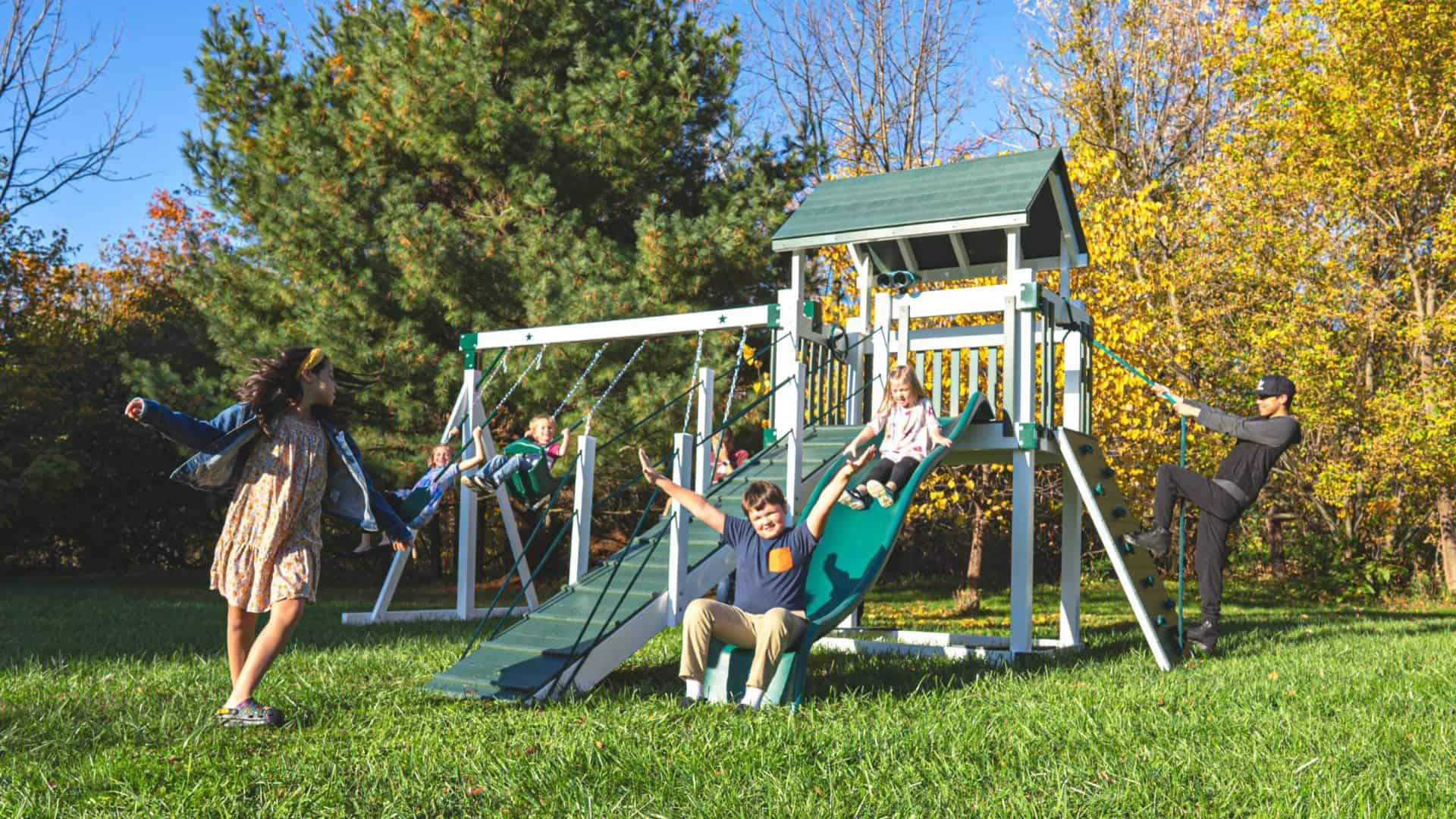 children playing on green and white silver star vinyl swing set for sale