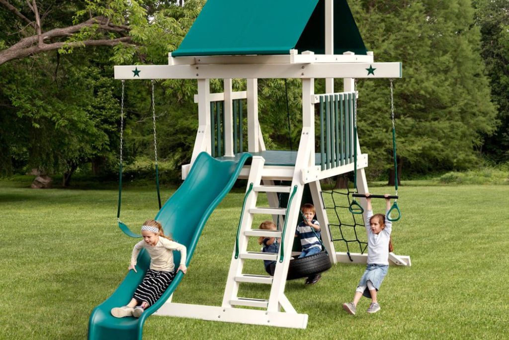 small backyard play structures with white and green vinyl 