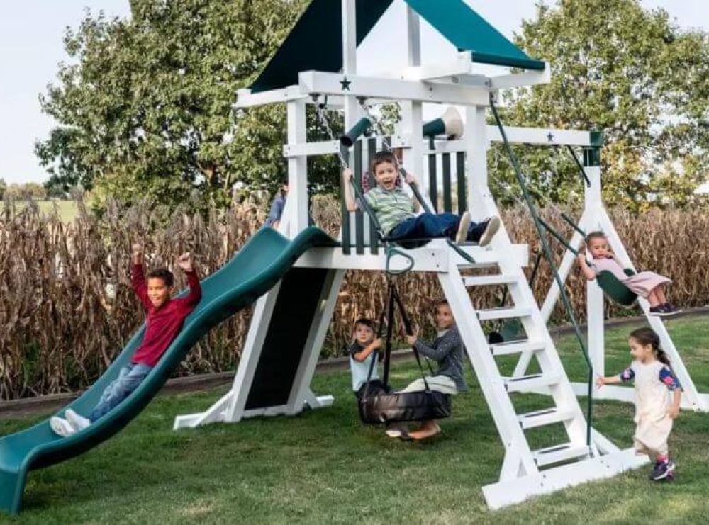tire swing set that is white and green with a small slide, playset tower, and more swings