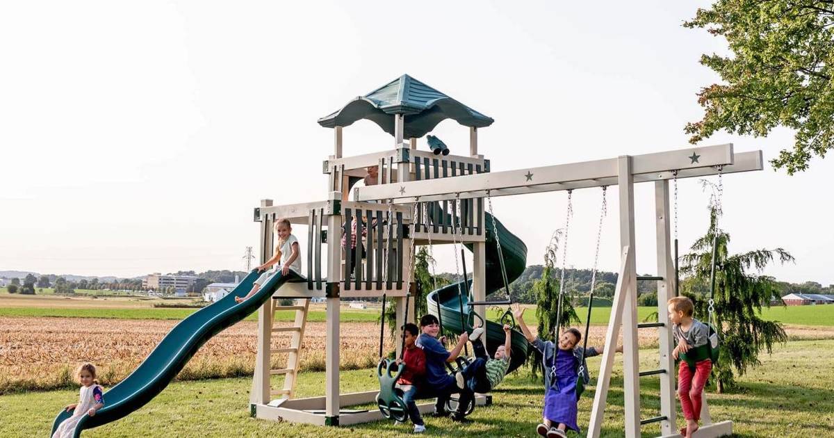 super star perfect swing set with kids playing in backyard