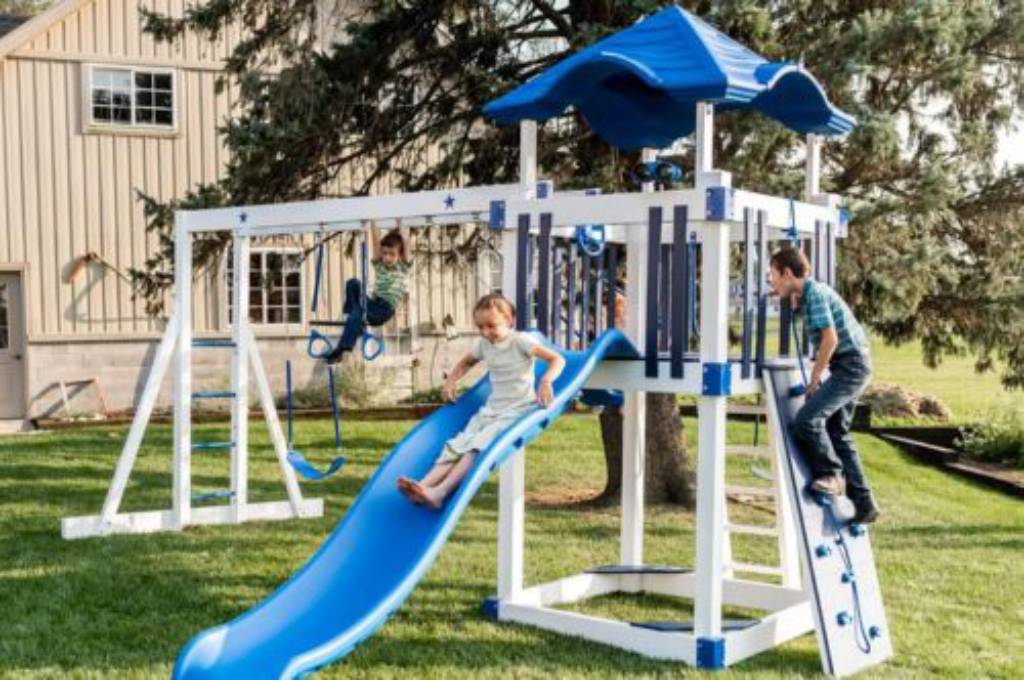 kids playing on blue playset playground called shooting star climber